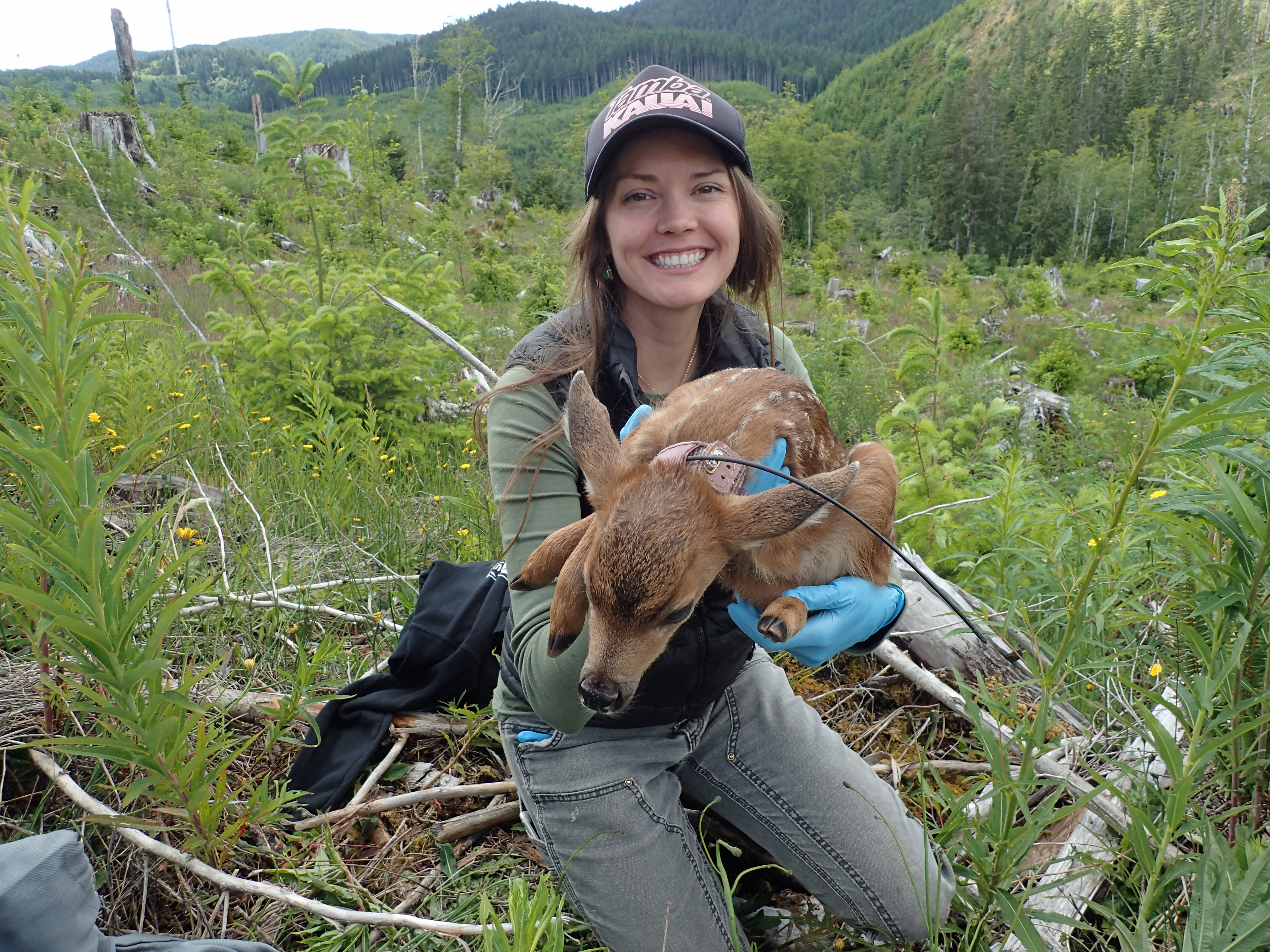 "Cameron Macias, Tribal member photographed holding a fawn"