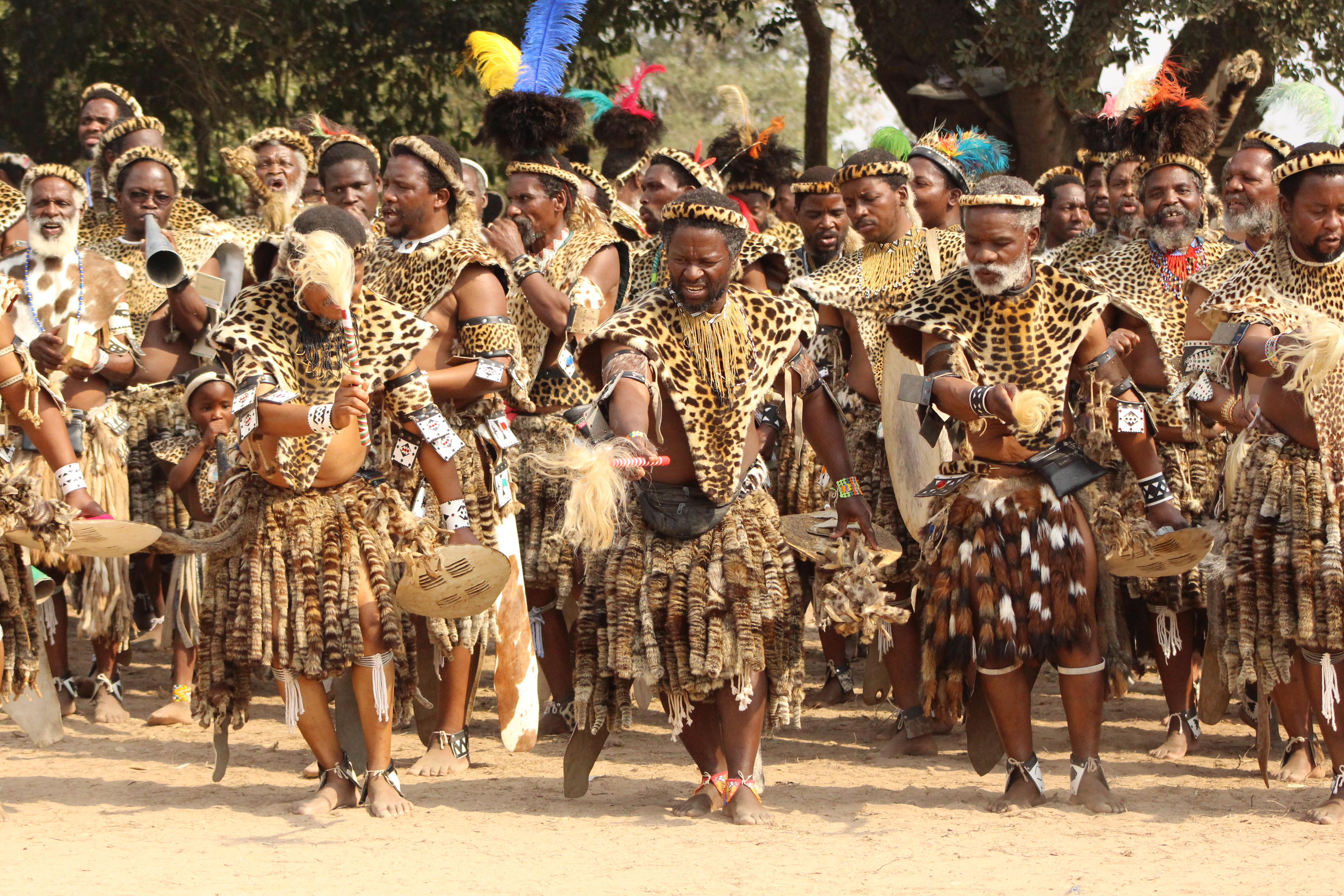 "African men dancing in leopard skin"
