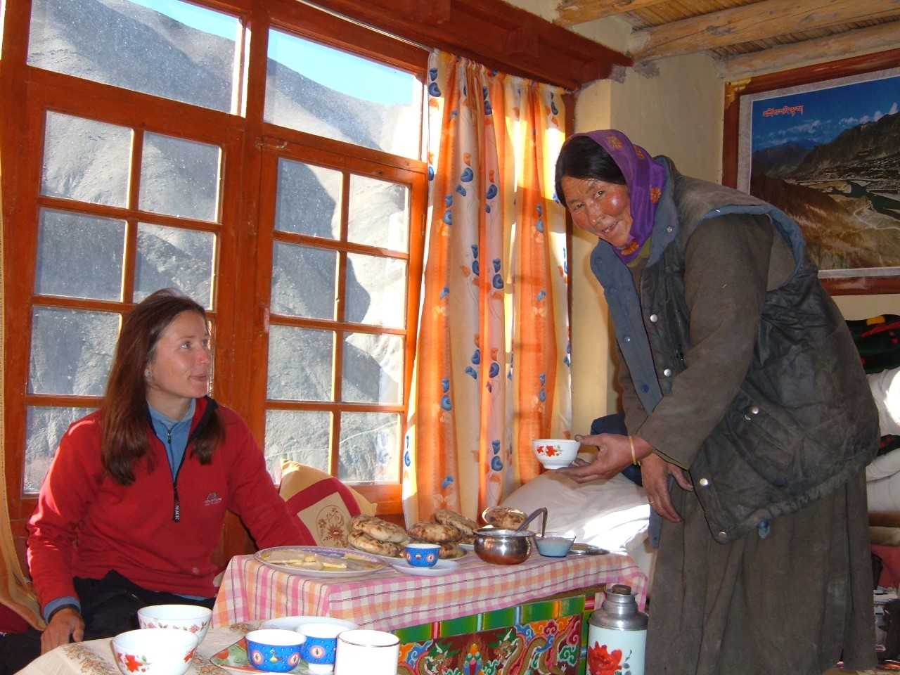 Homestay owner serving a guest