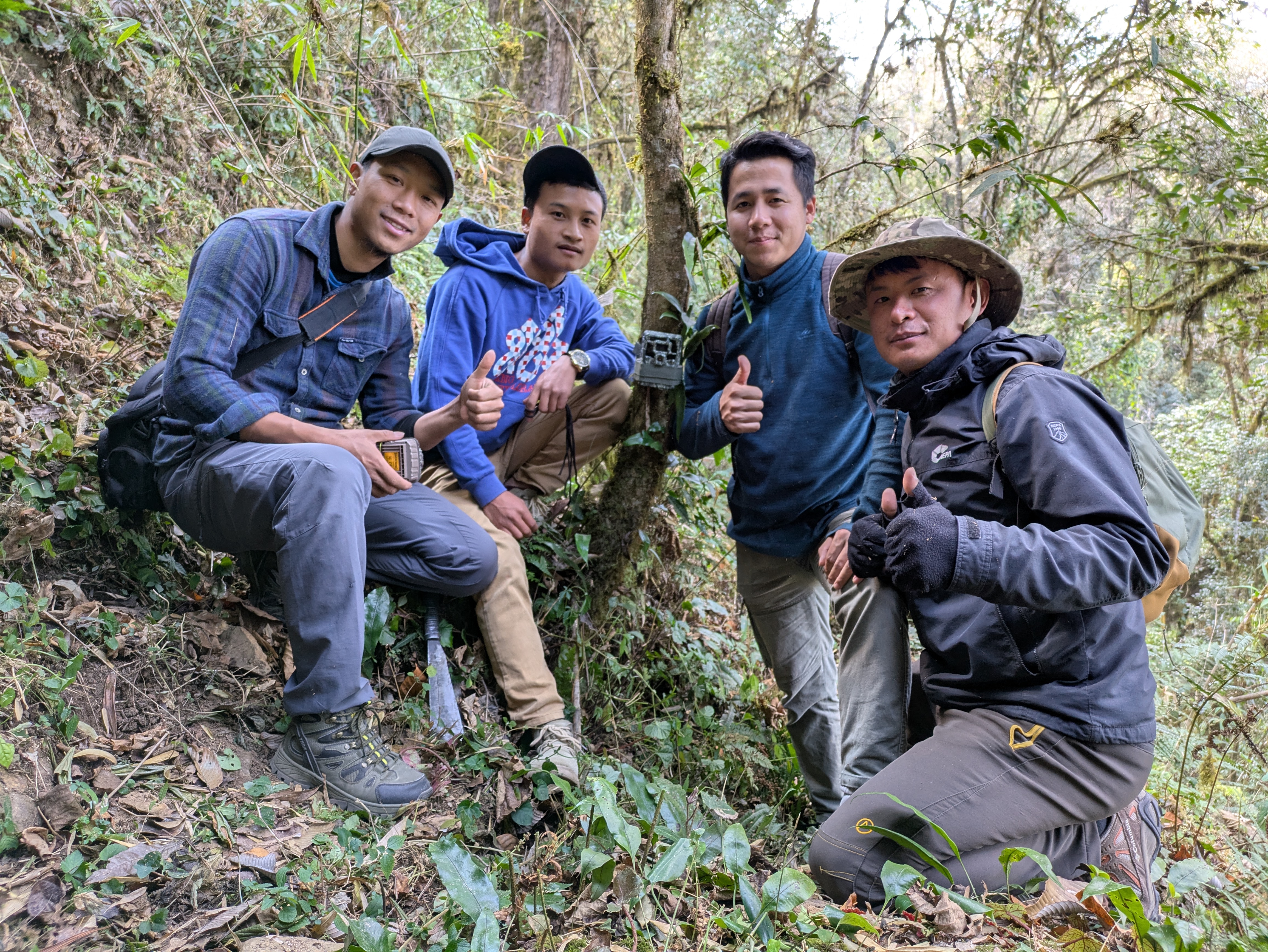 Team photo in from of a camera trap