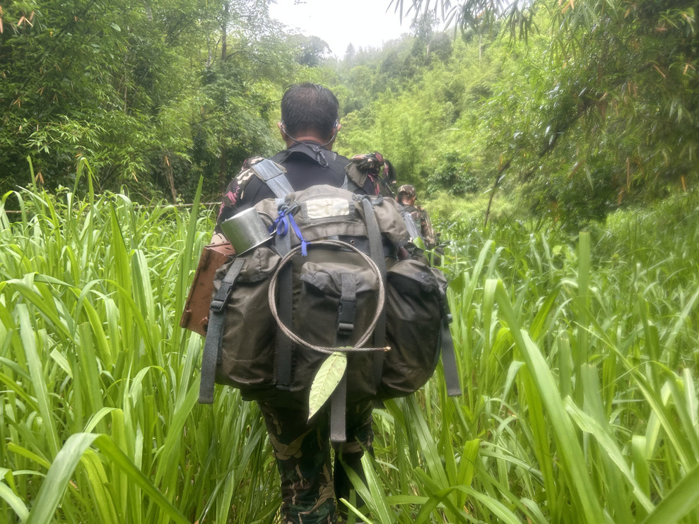 Ranger walking with heavy backpack