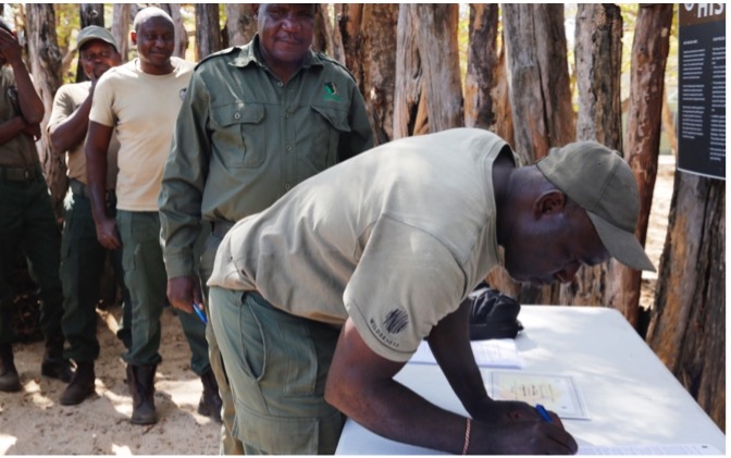 A man signs a piece of paper