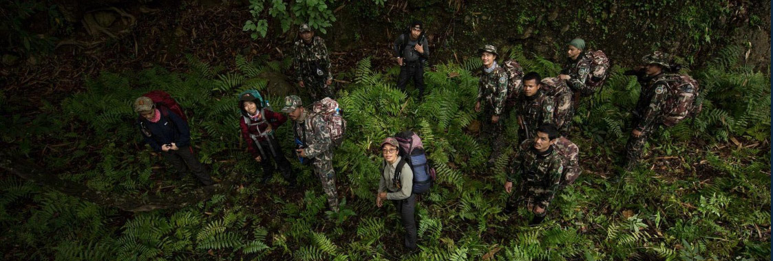 Wildlife rangers from Thailand's Department of National Parks, Wildlife and Plant Conservation, and Panthera trek through dense undergrowth in Thailand