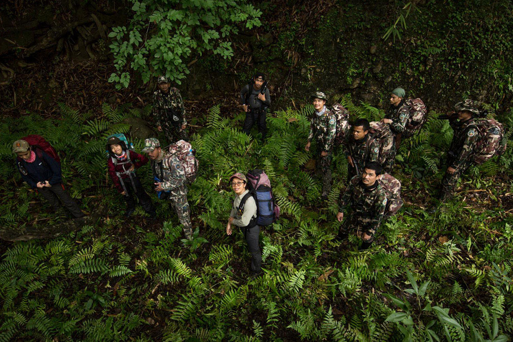 Wildlife rangers from Thailand's Department of National Parks, Wildlife and Plant Conservation, and Panthera trek through dense undergrowth in Thailand