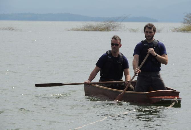 Two men rowing boat